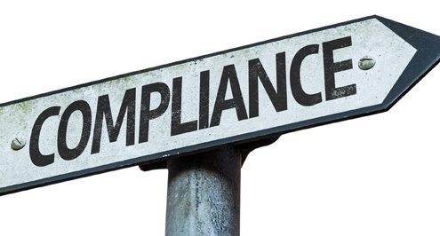 A sign points to the compliance audit road.
