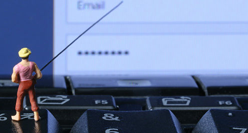 A little plastic man phishing for emails as a representation of cyberthreats.