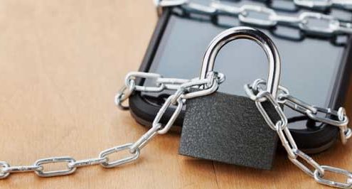 Hacking methods symbolized by a lock and mobile phone.